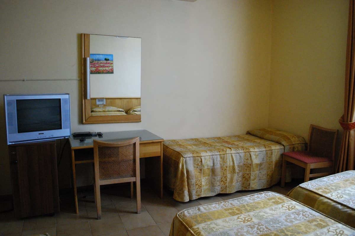 Standard Quadruple Room | Desk, blackout drapes, iron/ironing board, free WiFi