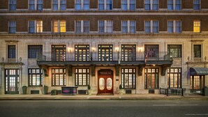 A historic building with a prominent entrance labeled "The Redmont." It features multiple windows, a balcony with railings, and a flag. - Redmont Hotel Birmingham, Curio Collection by Hilton (Birmingham)