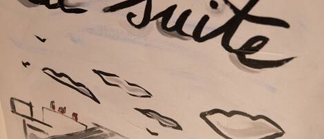 A sketch of a building with the text "la suite" indicating a suite room.