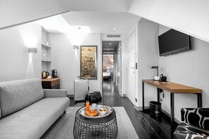 Suite | Living area | 40-inch LED TV with satellite channels, TV, iPod dock - Le Grey Hotel (Paris)