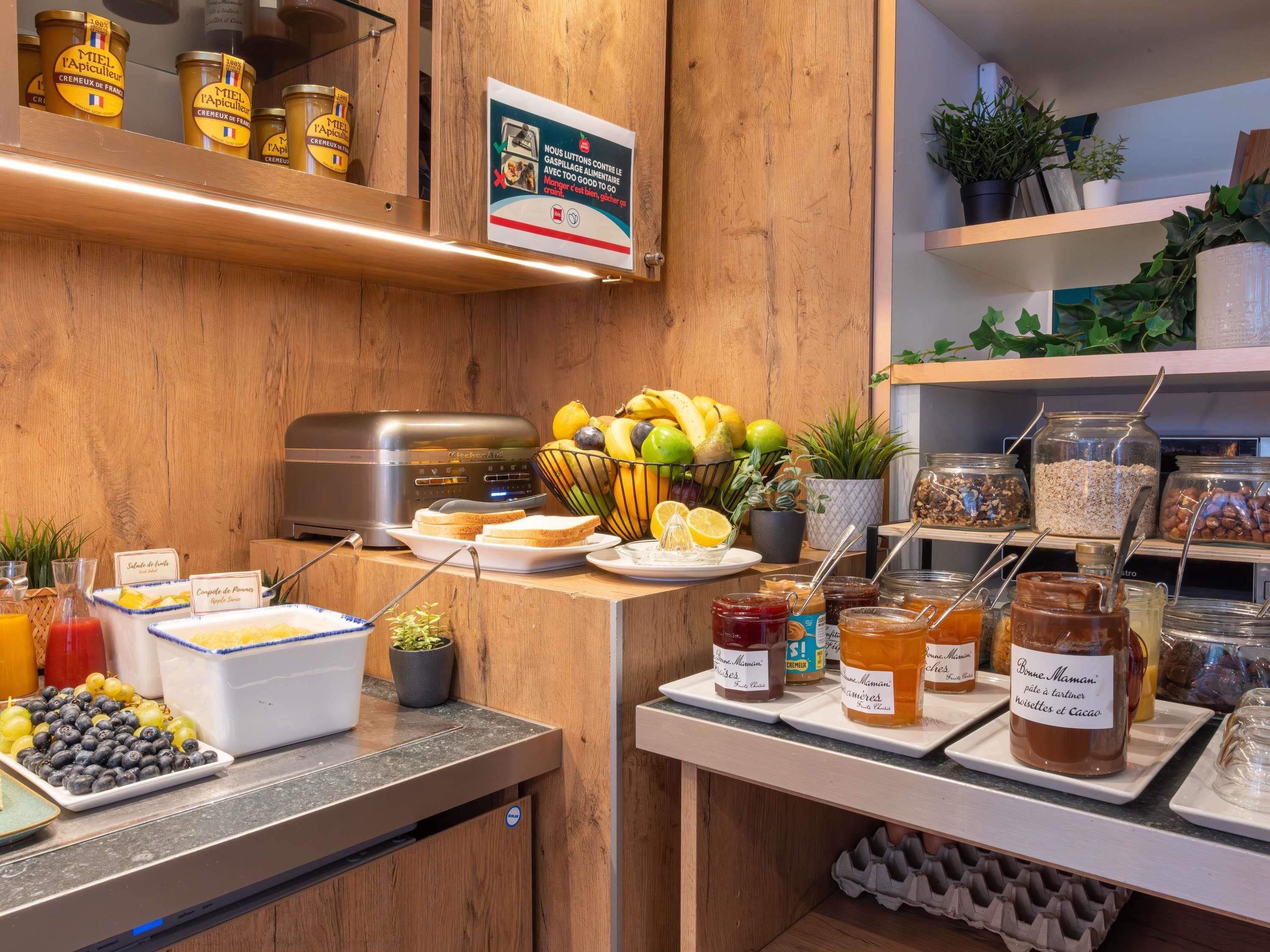 A breakfast buffet with various food items and condiments.