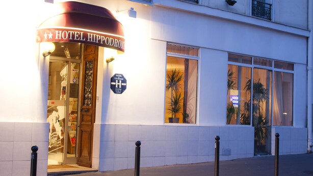 A hotel entrance with a sign reading "HOTEL HIPPODROMI" and a sign indicating it is a "HOTEL TOURISM". - Hotel Hippodrome (Paris)