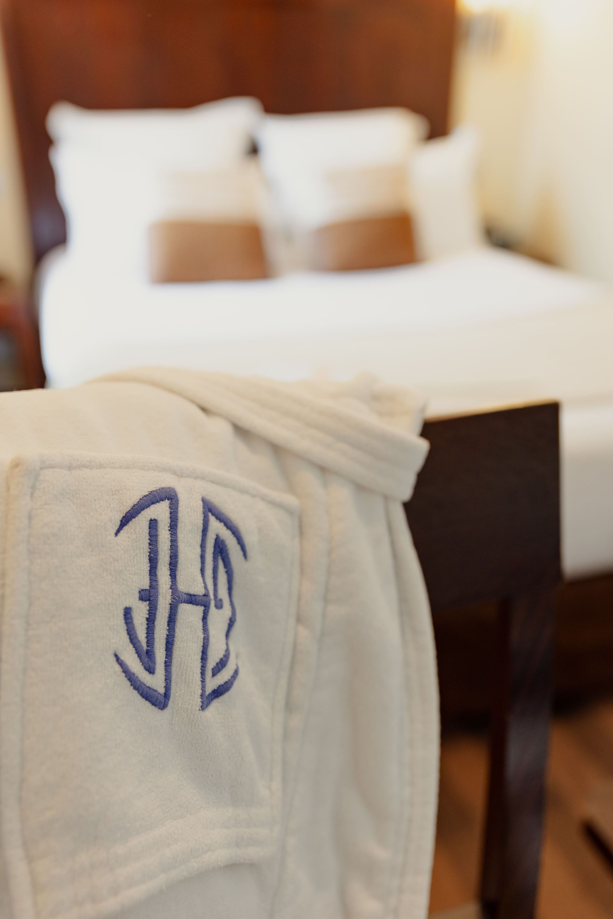 A bed with white bedding and a wooden headboard.