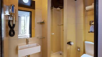 A bathroom with a sink, toilet, and shower.