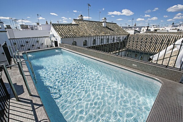 Outdoor pool, open 10:00 AM to 8:00 PM, pool umbrellas, pool loungers