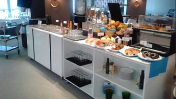 A buffet area with various food items and beverages.