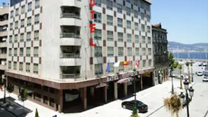 A multi-story hotel with a prominent 'HOTEL' sign on the facade. - Hotel Ciudad de Vigo (Vigo)