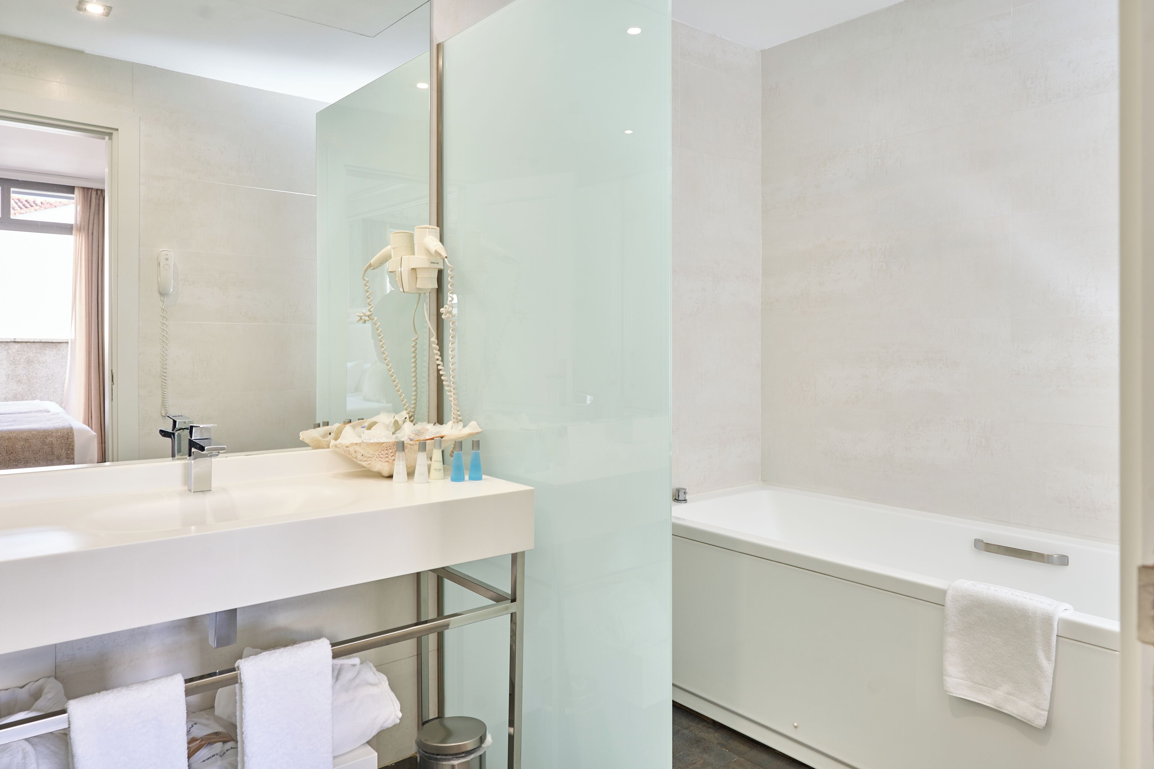 deep-soaking bathtub, designer toiletries, hair dryer, bidet