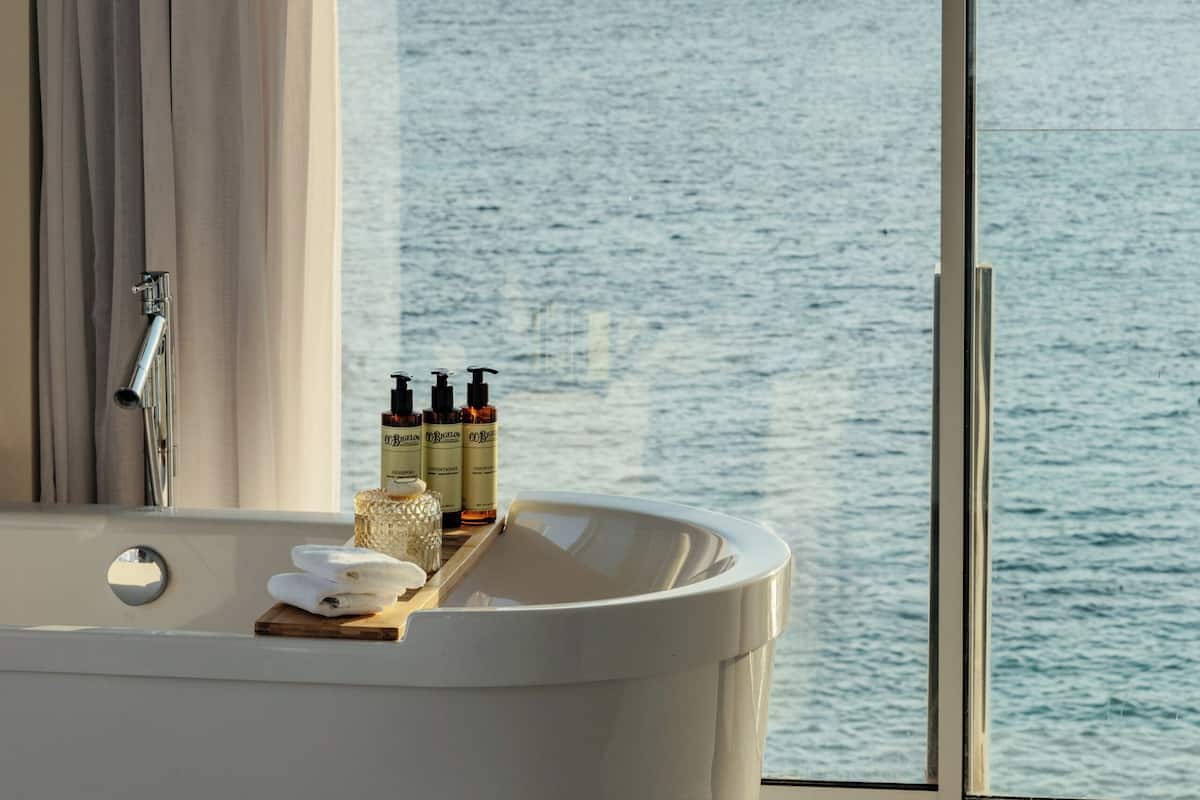 designer toiletries, hair dryer, bathrobes, slippers