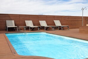 Seasonal outdoor pool, pool loungers