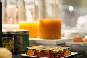 A breakfast buffet with various food items and condiments.