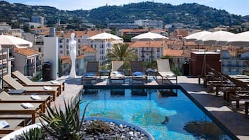 Seasonal outdoor pool, open 10:00 AM to 9:00 PM, pool umbrellas