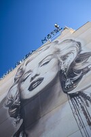 A mural of a woman with a blurred face on a building.