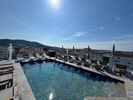Seasonal outdoor pool, open 10:00 AM to 9:30 PM, pool umbrellas