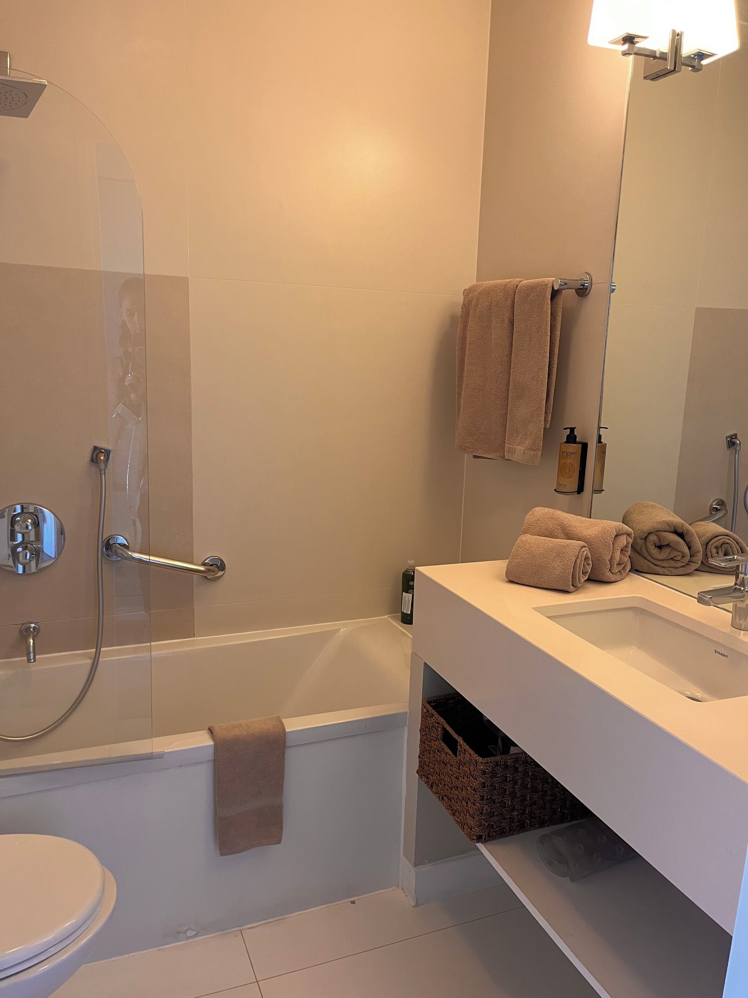 A bathroom with a bathtub, a toilet, and a sink.