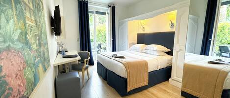 A hotel room with a bed, a desk, a chair, and a large window with curtains.