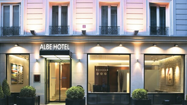 The exterior of the Albe Hotel with a modern facade, large windows, and a sign above the entrance. - Albe Hôtel Saint-Michel (Paris)
