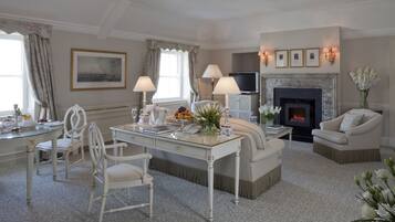 A well-appointed living room with a fireplace, comfortable seating, and a dining area.