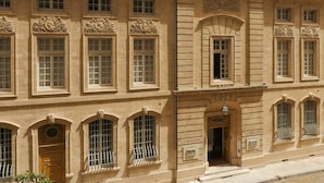 A historic building with multiple arched windows and a central entrance.