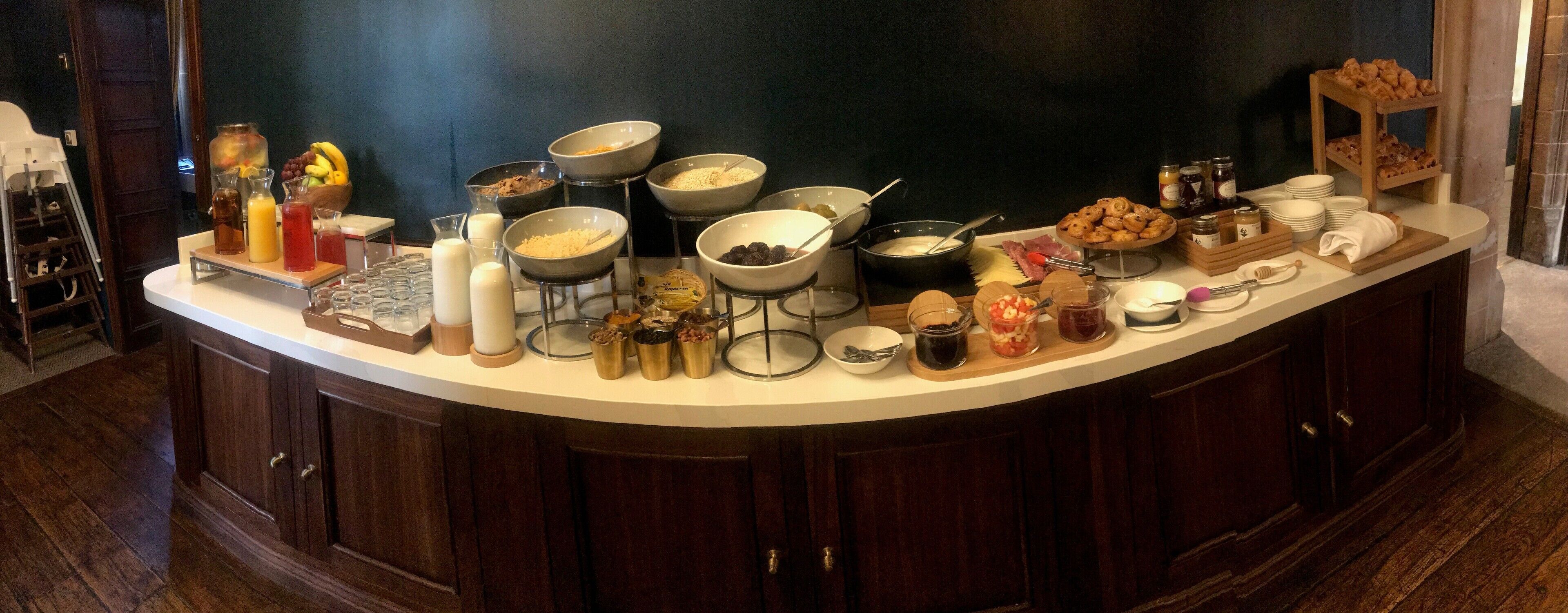 A breakfast buffet with various food items and beverages.