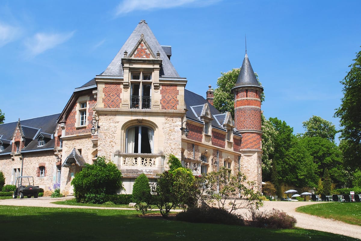 A large, historic building with a prominent tower and arched windows.