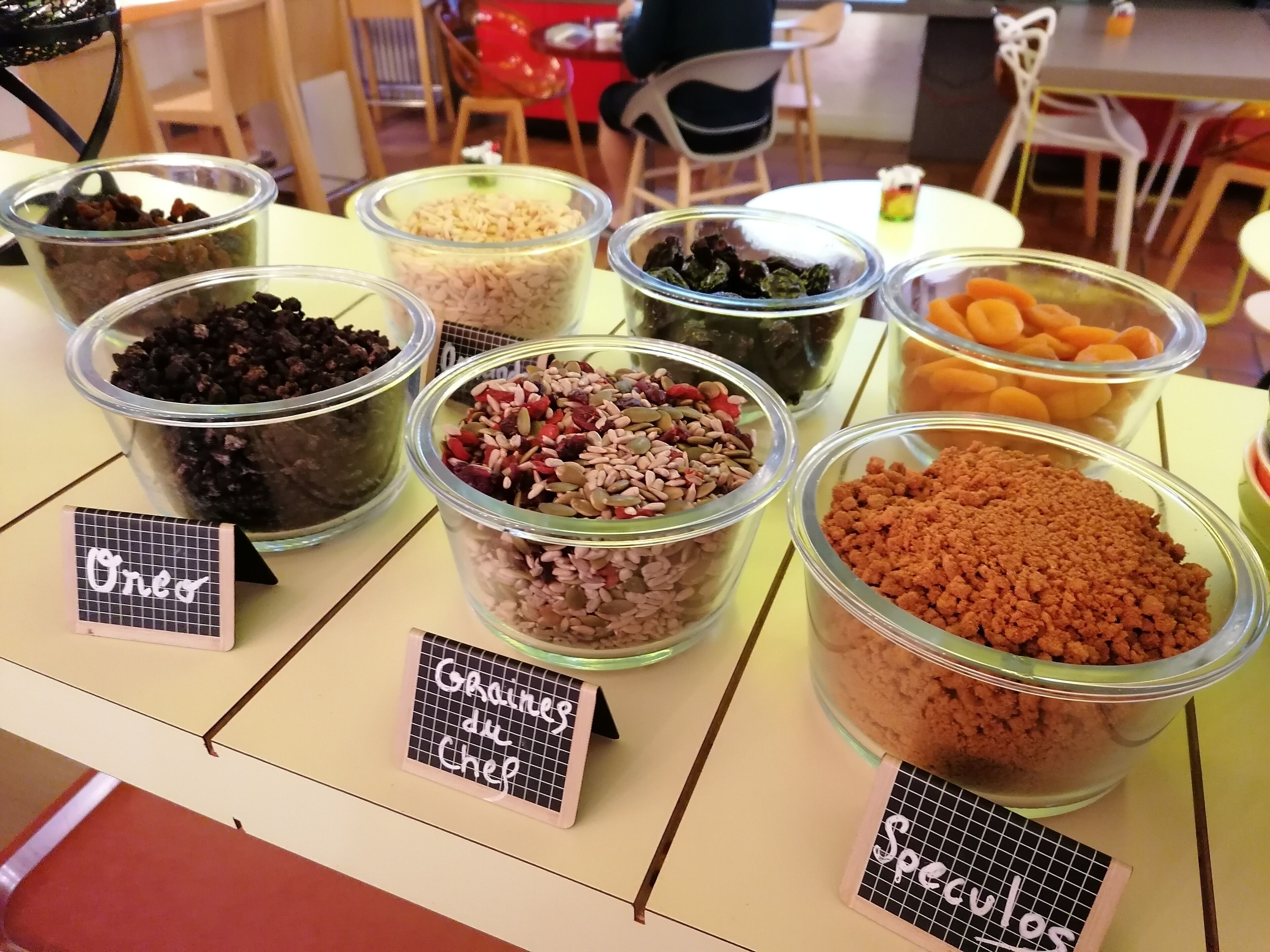 A display of various food items in clear containers with labels.