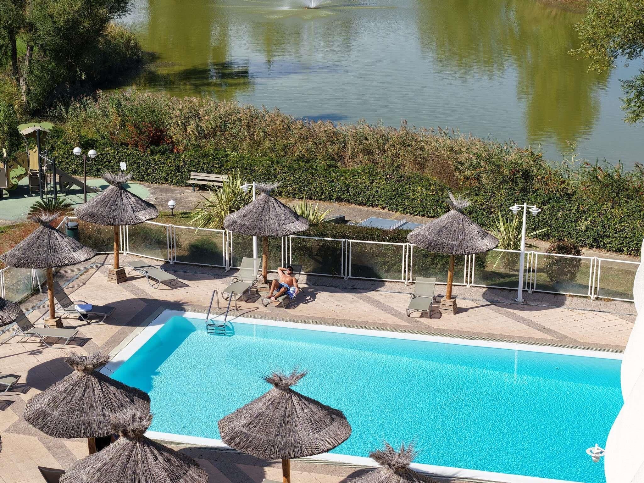 Seasonal outdoor pool, open 9:00 AM to 9:00 PM, pool umbrellas