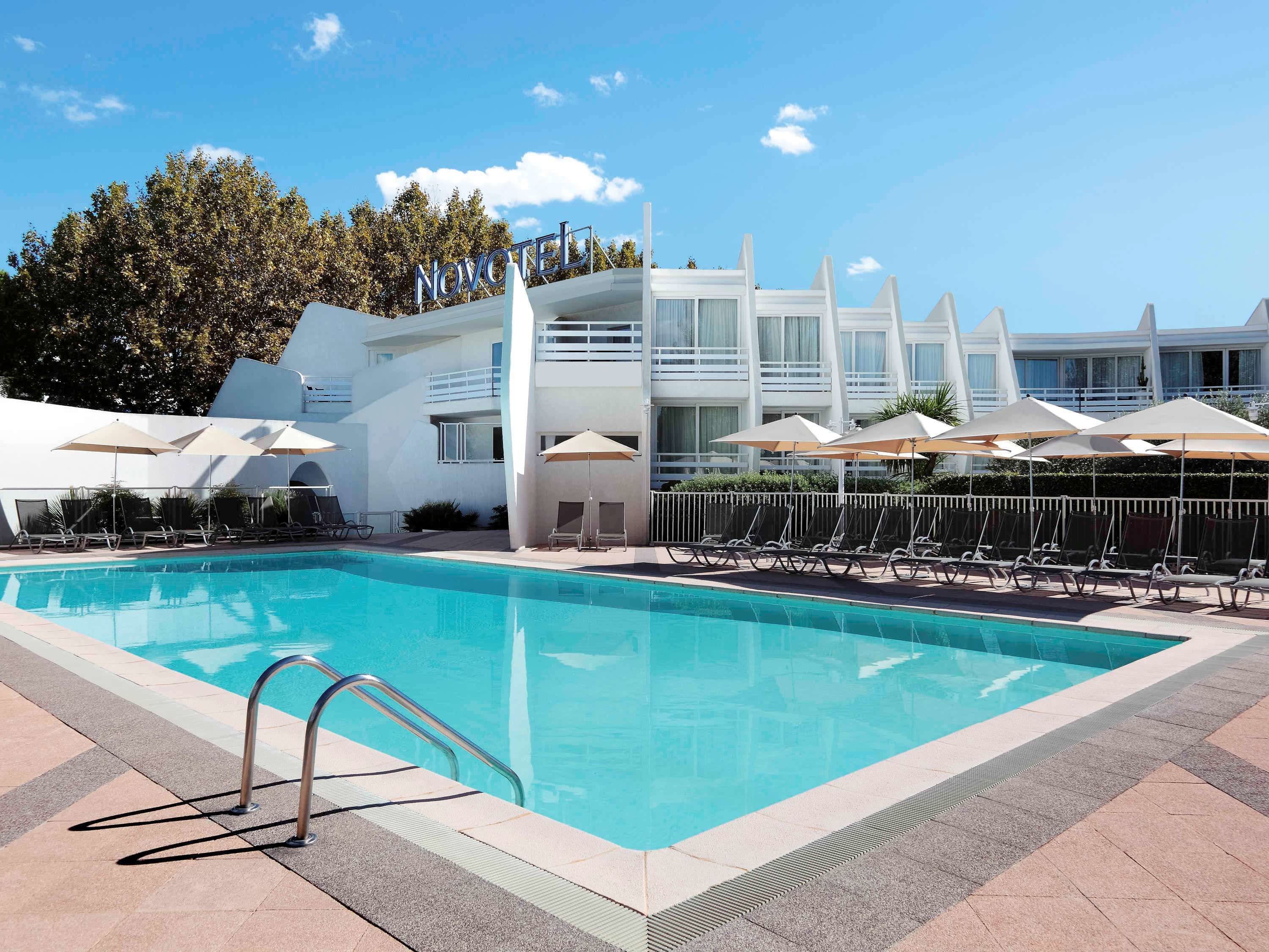 Seasonal outdoor pool, open 9:00 AM to 9:00 PM, pool umbrellas