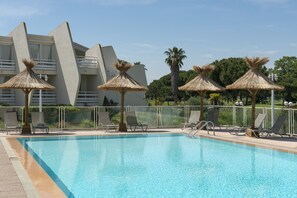 Seasonal outdoor pool, open 9:00 AM to 9:00 PM, pool umbrellas