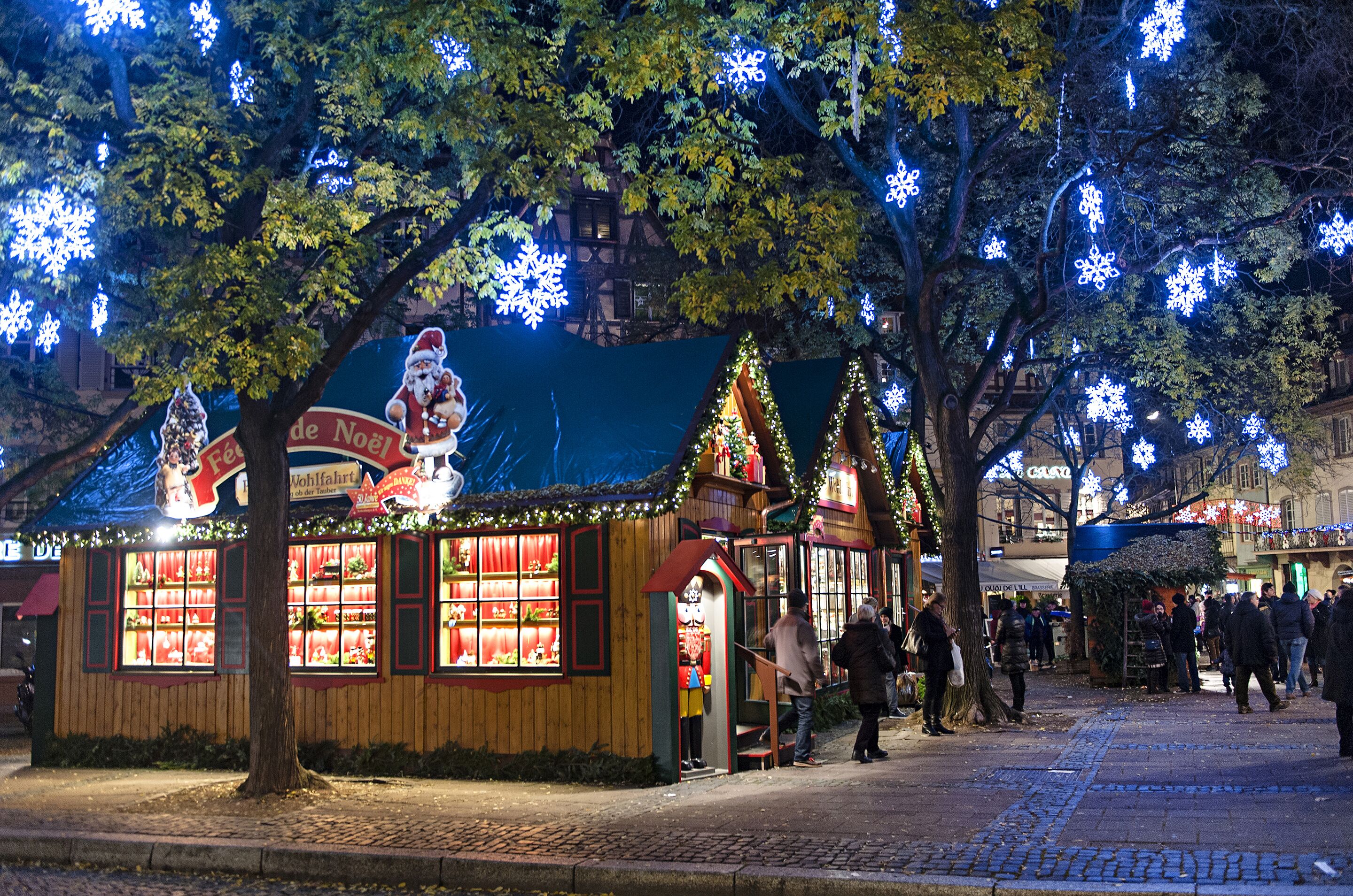A small, cozy building with a Christmas theme, including a Santa Claus figure and snowflake decorations.