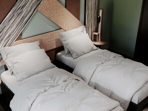 A modern hotel room with two single beds, a patterned wall, a tall bedside table, and a wall-mounted light fixture. - TRIBE Strasbourg Centre Gare (Strasbourg)