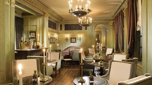 A luxurious room with ornate decor, including a chandelier, elegant chairs, and a well-lit ambiance. - Le Dokhan’s Paris Arc de Triomphe, a Tribute Portfolio Hotel (Paris)