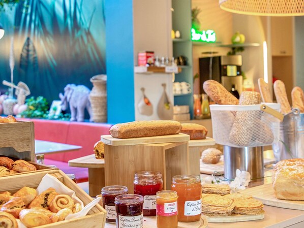 A bakery counter with various pastries, bread, and jars of preserves.