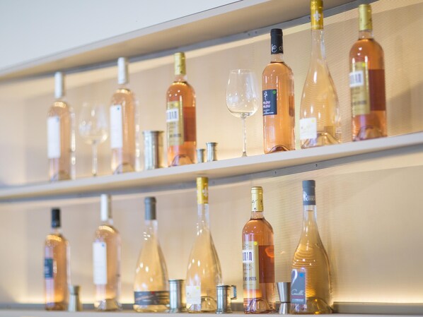 A bar area with shelves of wine bottles and glasses.