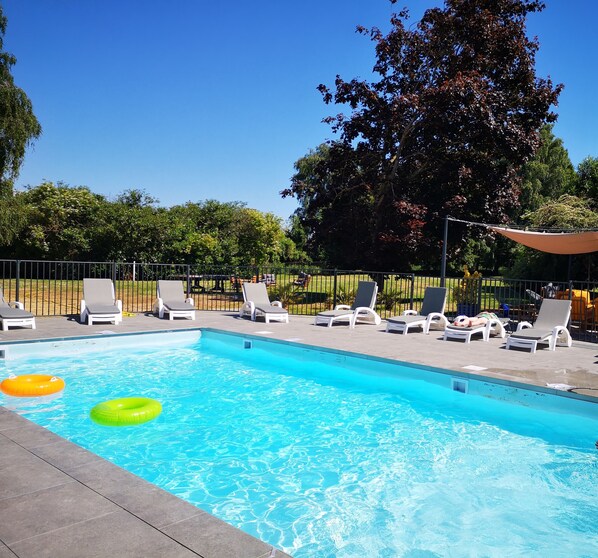 Outdoor pool, open 10:00 AM to 7:00 PM, pool loungers