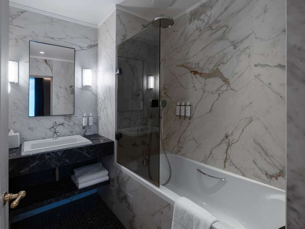 deluxe room, 1 king bed | bathroom | combined shower/bathtub, deep-soaking bathtub, eco-friendly toiletries