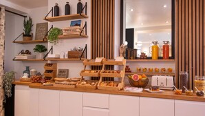 A breakfast buffet with various food items and a coffee station. - La Manufacture (Paris)