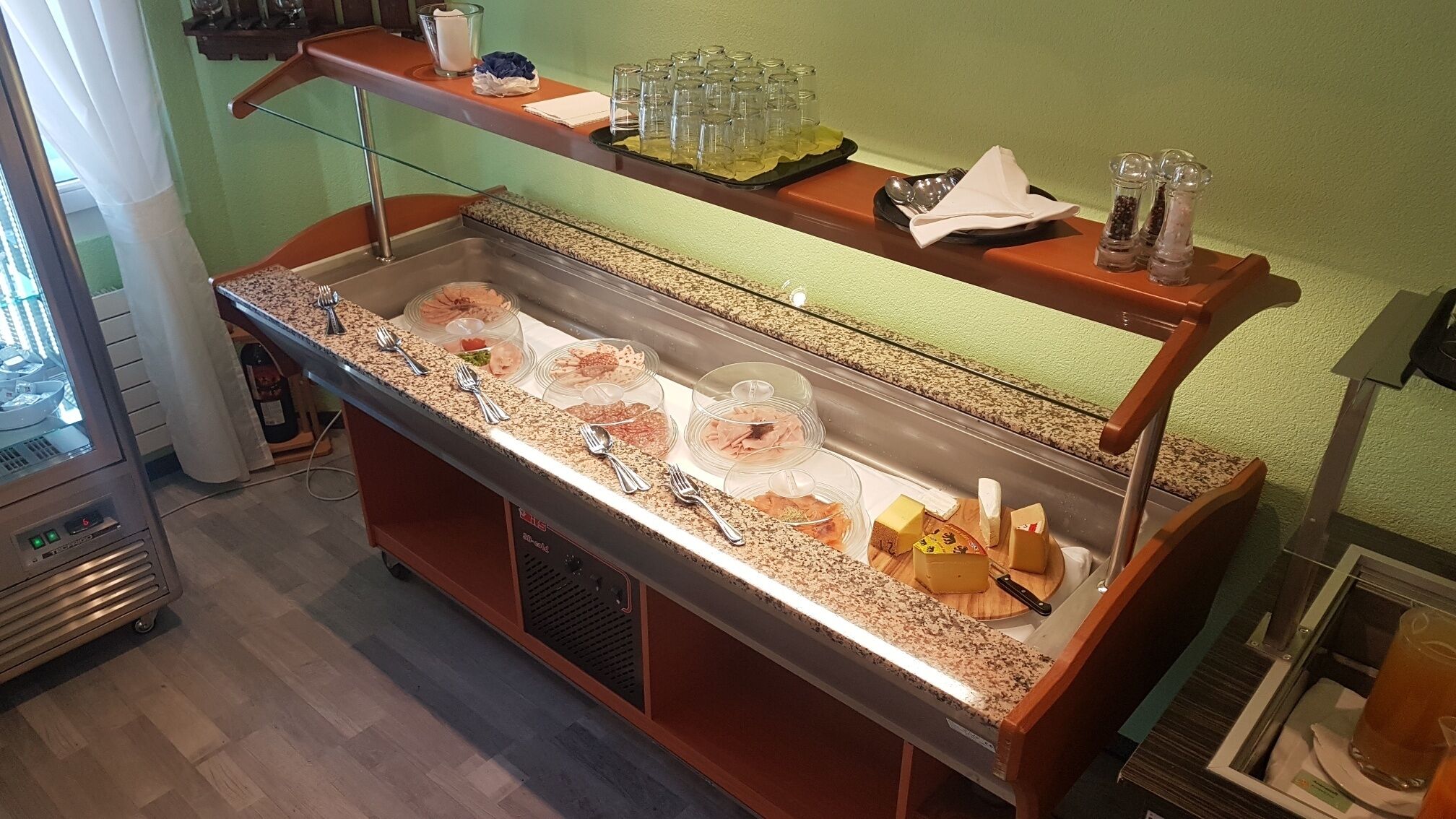 A buffet setup with various food items and condiments.