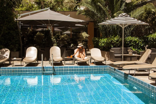 Outdoor pool, open 8:30 AM to 2:30 PM, pool umbrellas, pool loungers