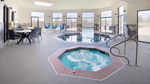A hotel lobby with a pool area, seating, and a reception desk. - Comfort Inn & Suites Wichita Northeast (Wichita)