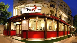 A P&P restaurant with a red facade, large windows, and a curved entrance. - Hotel Ambassador Monaco (Monaco)