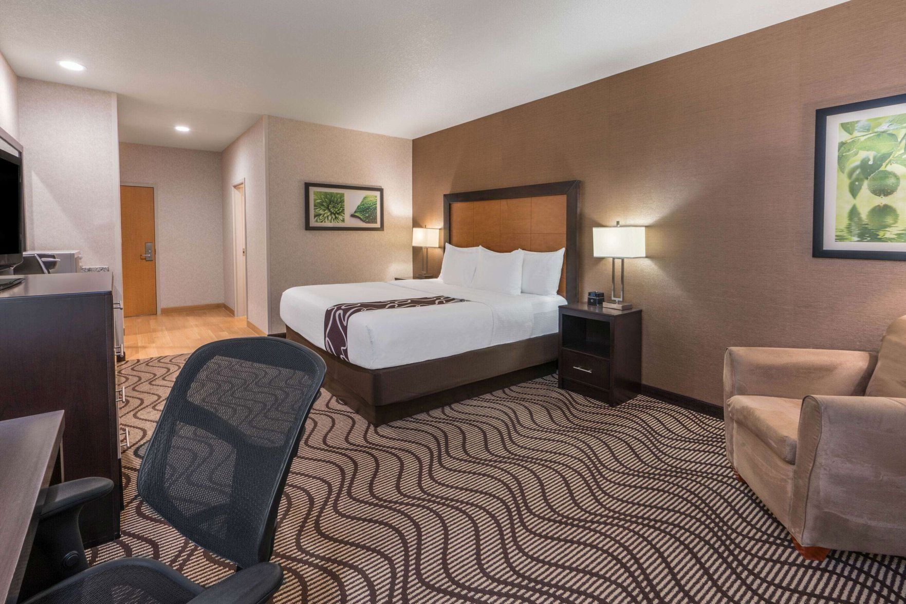 Premium bedding, desk, laptop workspace, blackout drapes