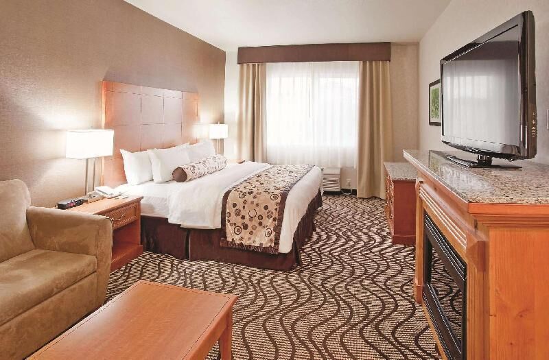 Premium bedding, desk, laptop workspace, blackout drapes