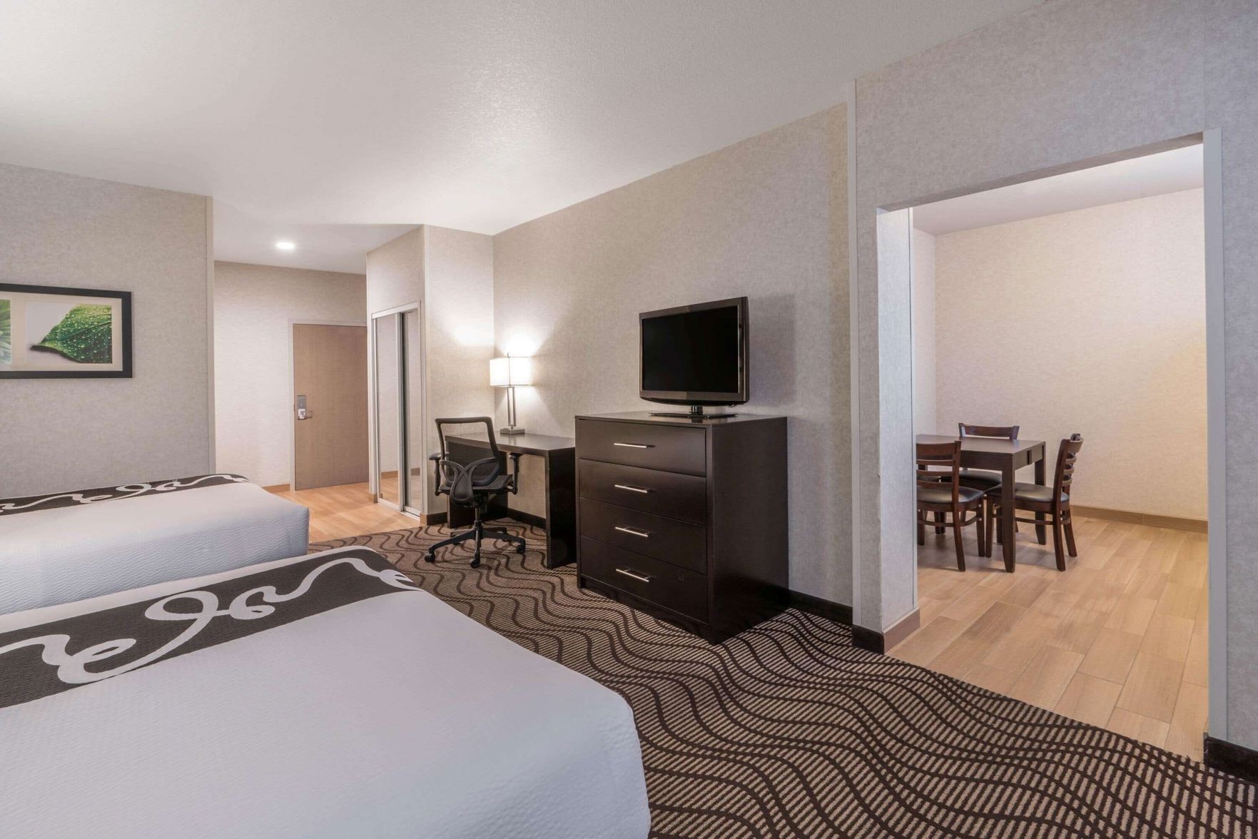 Premium bedding, desk, laptop workspace, blackout drapes