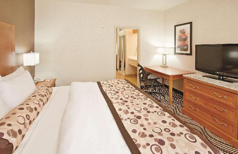 Premium bedding, desk, laptop workspace, blackout drapes