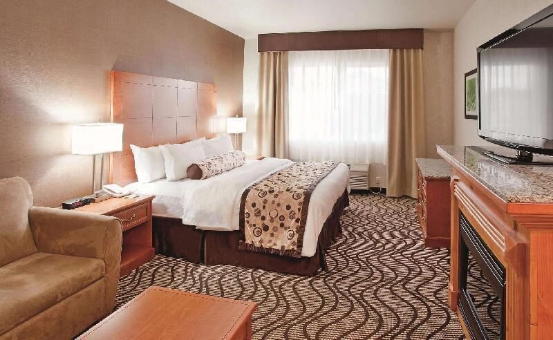 Premium bedding, desk, laptop workspace, blackout drapes