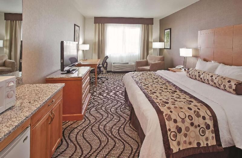 Premium bedding, desk, laptop workspace, blackout drapes