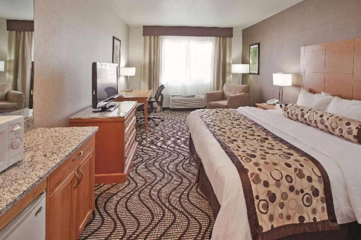 Premium bedding, desk, laptop workspace, blackout drapes