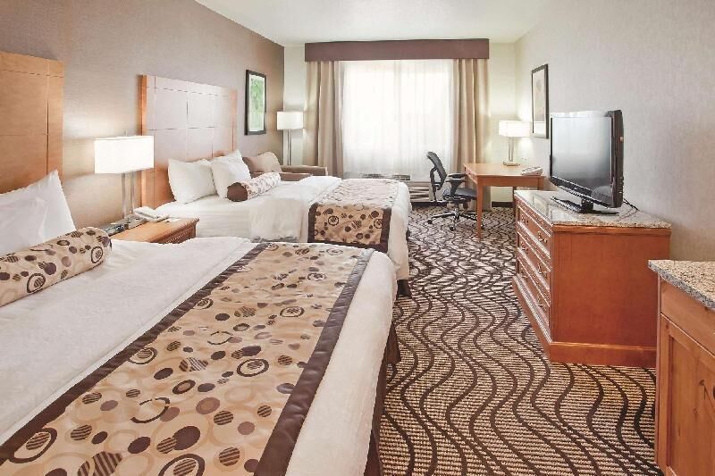 Premium bedding, desk, laptop workspace, blackout drapes