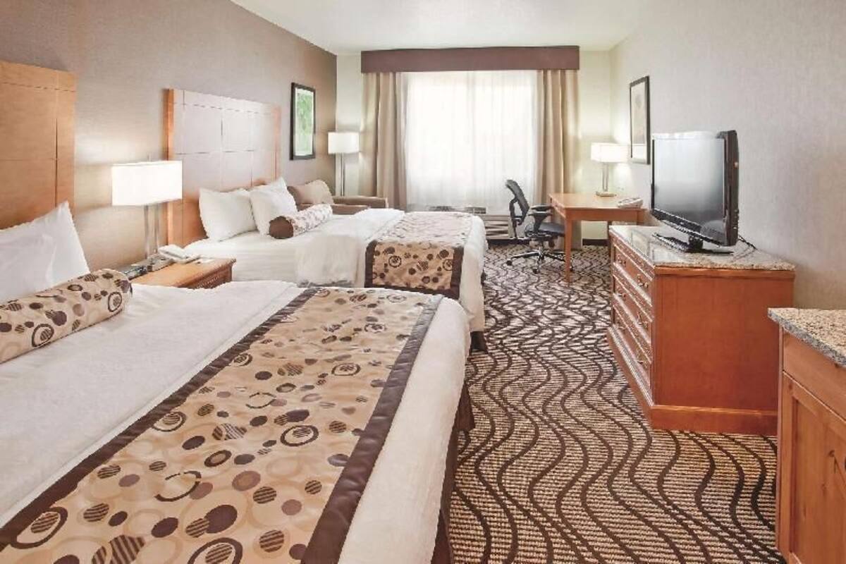 Premium bedding, desk, laptop workspace, blackout drapes